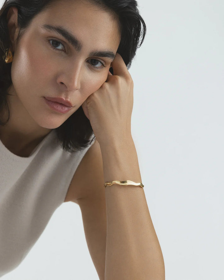 Wavy bolded cuff gold bracelet